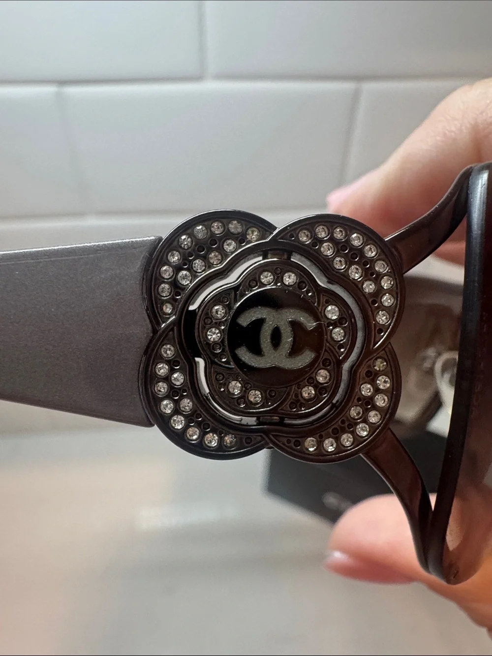 Chanel  Camellia flower with crystal-embellished interlocking CC logo